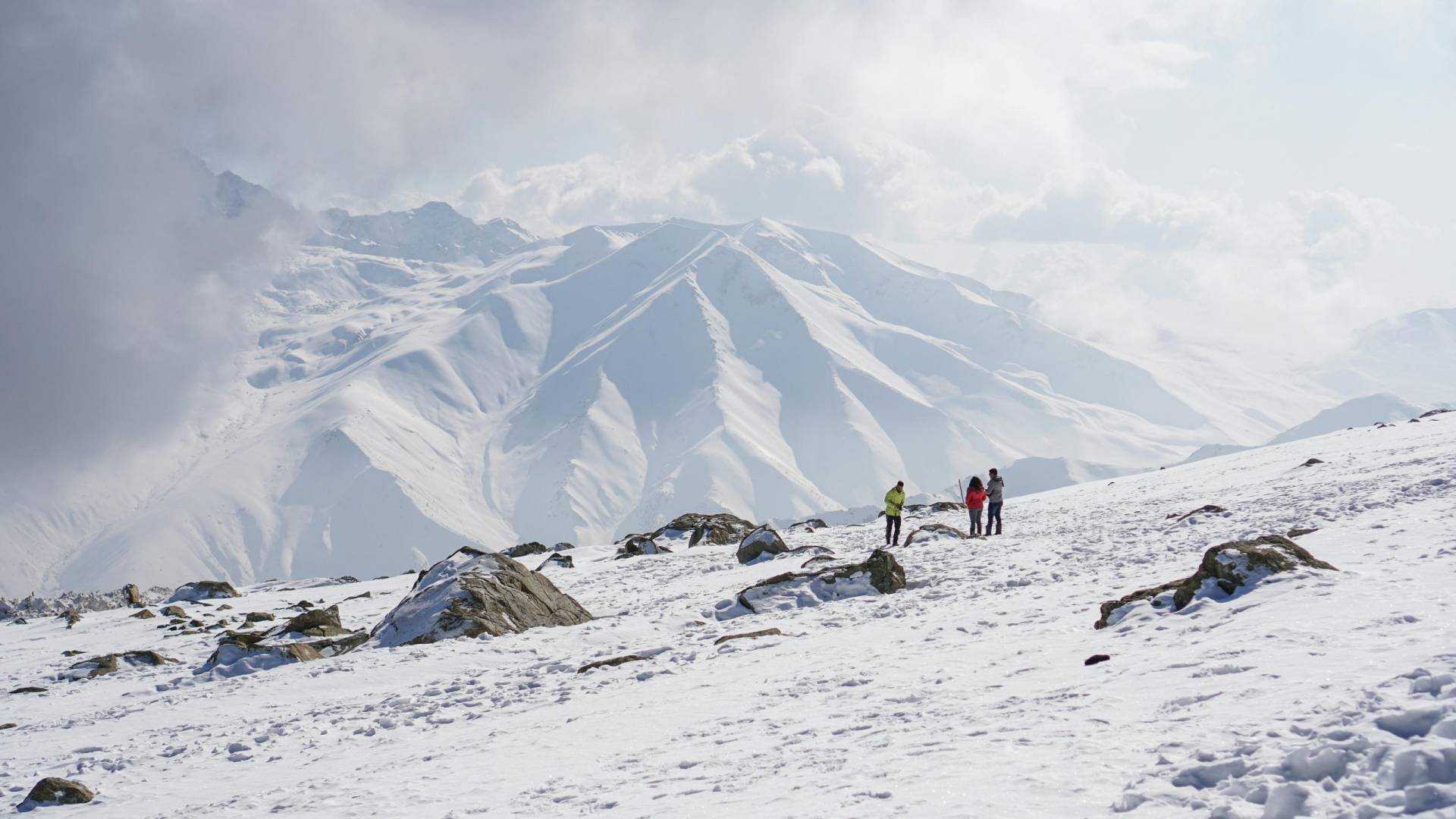 Hikers enjoy a breathtaking winter trek through snow-covered peaks in Kashmir, India.